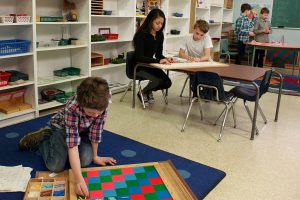 Children independently doing different activities in the classroom